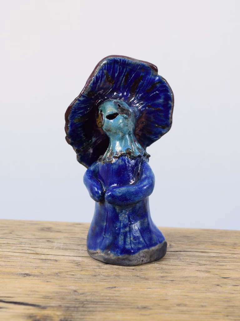 Daphne, a raku-fired ceramic mushroom lady in deep cobalt blue with a wide cap